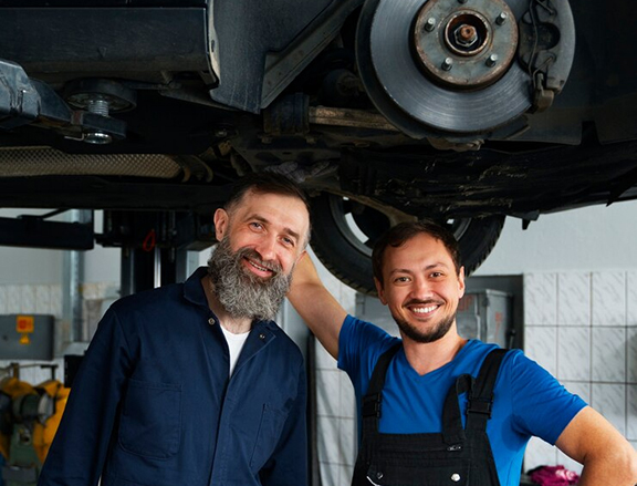 Technician replacing brake pads as part of brake repair shop in Dubai service