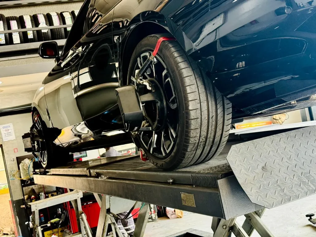 Technician balancing a wheel at a Best tyre shop in Dubai facility